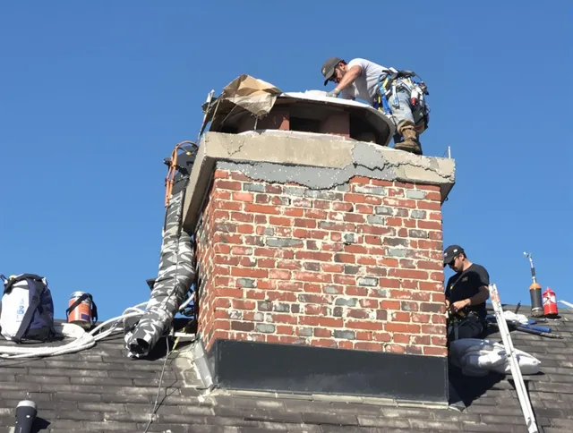 Wrentham Chimney Sweep installing a custom chimney crown in Wrentham, MA