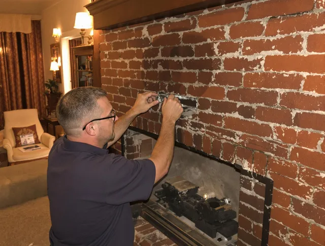 Wrentham Chimney Sweep expert fixing a fireplace in Wrentham, MA